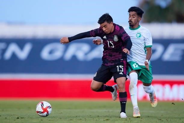 Carlos Uriel Antuna of Mexico competes for the ball with Aiman Al Kulaif of Saudi Arabia during a International Friendly Match between Mexico and...