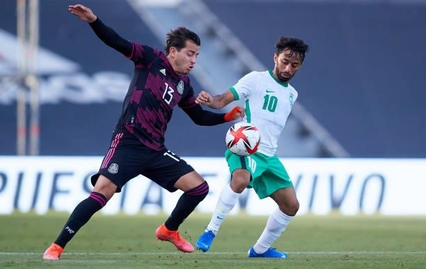 Alan Mozo Rodriguez of Mexico competes for the ball with Aiman Al Kulaif of Saudi Arabia during a International Friendly Match between Mexico and...