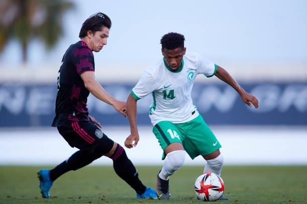 Alan Cervantes of Mexico competes for the ball with Aiman Al Kulaif of Saudi Arabia during a International Friendly Match between Mexico and Saudi...