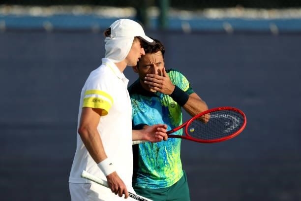 Marc Polmans of Australia and Artem Sitak of New Zealand discuss in their double match against Ryan Peniston and Liam Broady of Great Britain during...