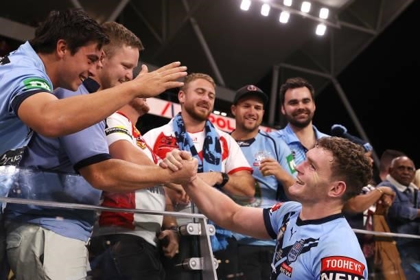Liam Martin of the Blues poses with fans after winning game one of the 2021 State of Origin series between the New South Wales Blues and the...