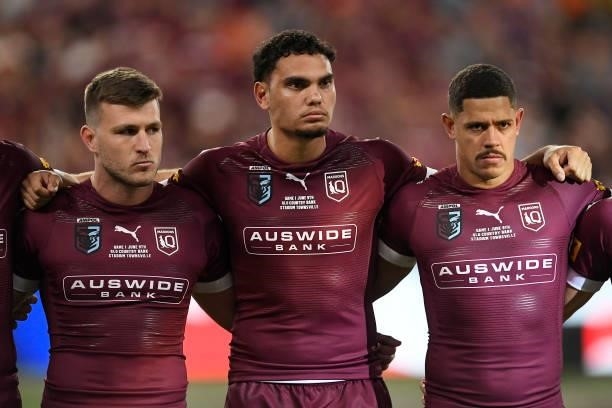 Jai Arrow of the Maroons, Xavier Coates of the Maroons and Dane Gagai of the Maroons sing the national anthem before game one of the 2021 State of...