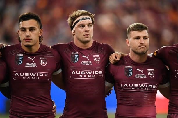 Tino Fa'asuamaleaui of the Maroons, Christian Welch of the Maroons and Jai Arrow of the Maroons sing the national anthem before game one of the 2021...