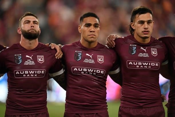 Kyle Feldt of the Maroons, Joe Ofahengaue of the Maroons and Tino Fa'asuamaleaui of the Maroons sing the national anthem before game one of the 2021...