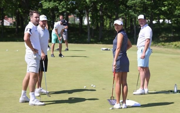 Toby Tree, Amy Boulden of Wales and Jamie Donaldson of Wales look on from the putting green ahead of the Scandinavian Mixed Hosted by Henrik and...