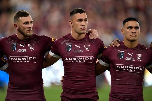 Kurt Capewell of the Maroons, Jayden Su'A of the Maroons and Valentine Holmes of the Maroons sing the national anthem before game one of the 2021...