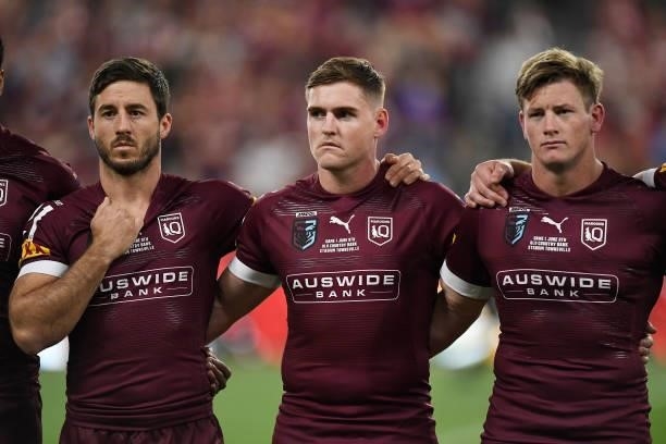 Ben Hunt of the Maroons, Alexander Brimson of the Maroons and Harry Grant of the Maroons sing the national anthem before game one of the 2021 State...