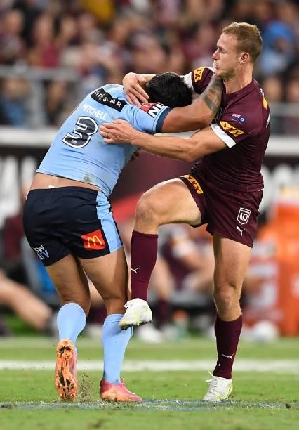 Latrell Mitchell of the Blues is tackled by Daly Cherry-Evans of the Maroons during game one of the 2021 State of Origin series between the New South...