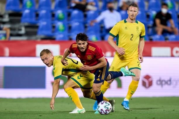 Brahim Diaz of Spain U21 battle for the ball with Domantas Simkus of Lithuania during the international friendly match between Spain U21 and...