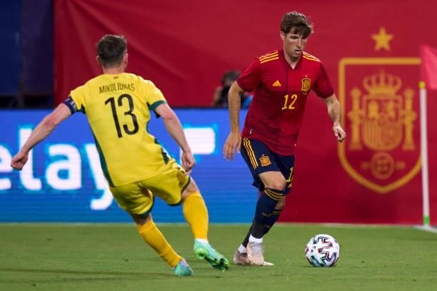 Juan Miranda of Spain U21 battle for the ball with Saulius Mikoliunas of Lithuania during the international friendly match between Spain U21 and...