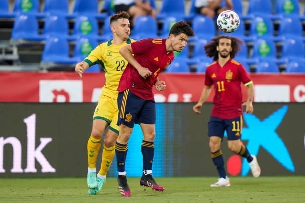 Hugo Guillamon of Spain U21 battle for the ball with Fedor Chernykh of Lithuania during the international friendly match between Spain U21 and...