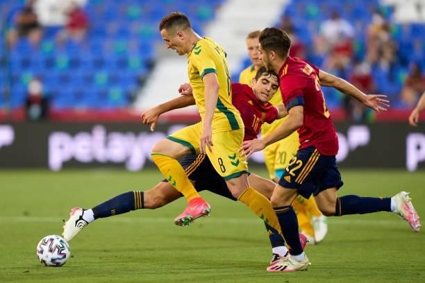 Gonzalo Villar of Spain U21 battle for the ball with Egidijus Vaitkunas of Lithuania during the international friendly match between Spain U21 and...