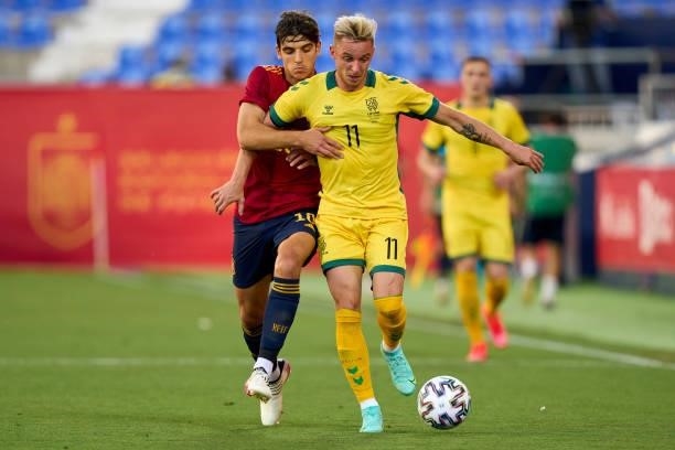 Gonzalo Villar of Spain U21 battle for the ball with Arvydas Novikovas of Lithuania during the international friendly match between Spain U21 and...