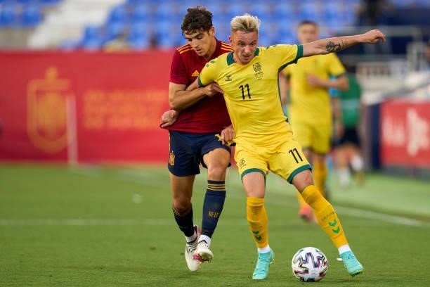 Gonzalo Villar of Spain U21 battle for the ball with Arvydas Novikovas of Lithuania during the international friendly match between Spain U21 and...