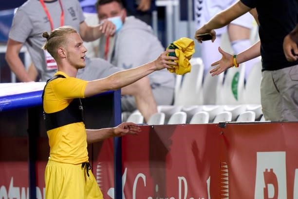 Justas Lasickas of Lithuania gives his jersey to the fans after the game to the fans during the international friendly match between Spain U21 and...