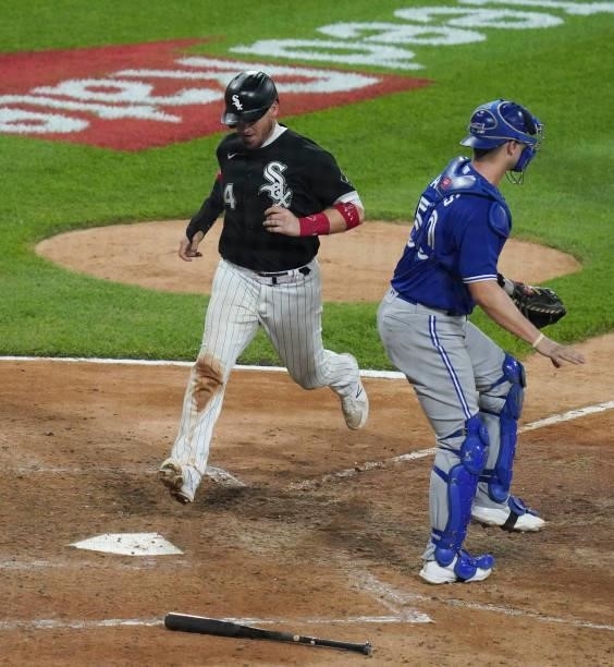 Yasmani Grandal of the Chicago White Sox scores during the eighth inning of a game against the Toronto Blue Jays at Guaranteed Rate Field on June 08,...