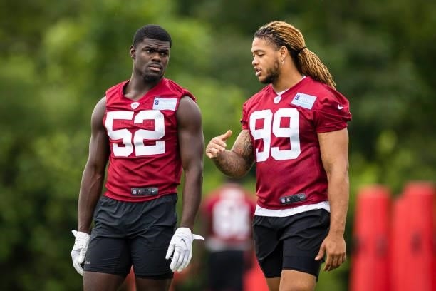 Chase Young speaks with Jamin Davis of the Washington Football Team during mandatory minicamp at Inova Sports Performance Center on June 9, 2021 in...