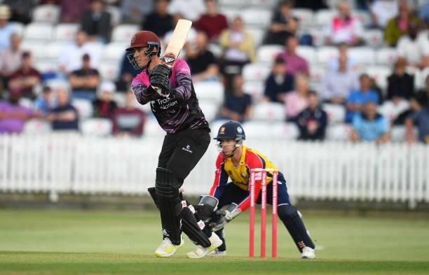 Tom Banton of Somerset plays a shot as Adam Wheater of Essex looks on during the Vitality T20 Blast match between Somerset and Essex at The Cooper...