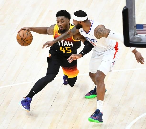 Donovan Mitchell of the Utah Jazz drives into Marcus Morris Sr. #8 of the LA Clippers in Game One of the Western Conference second-round playoff...
