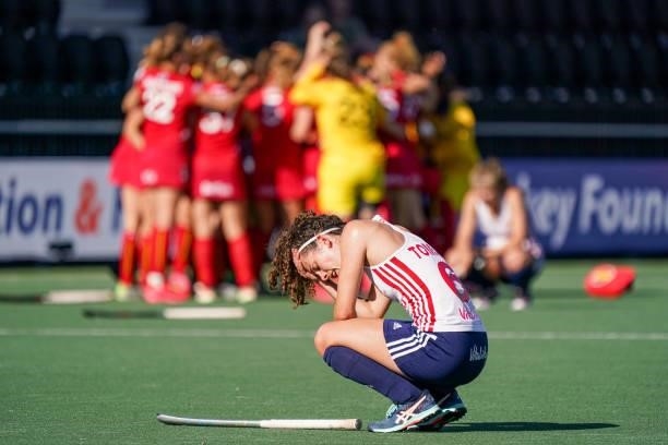 Anna Toman of England disappointed after defeat, background: Team of Belgium celebrating victory during the Euro Hockey Championships match between...