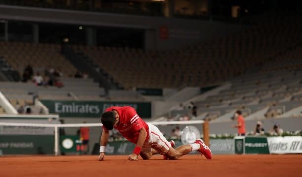 Novak Djokovic of Serbia falls to the floor during his Mens Singles Quarter-Final match against Matteo Berrettini of Italy during Day Eleven of the...