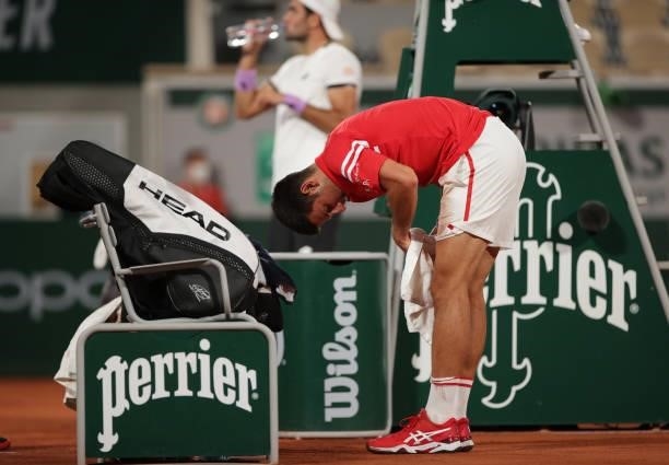 Novak Djokovic of Serbia wipes himself down during his Mens Singles Quarter-Final match against Matteo Berrettini of Italy during Day Eleven of the...