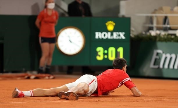 Novak Djokovic of Serbia falls over during his Mens Singles Quarter-Final match against Matteo Berrettini of Italy during Day Eleven of the 2021...