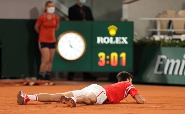 Novak Djokovic of Serbia falls over during his Mens Singles Quarter-Final match against Matteo Berrettini of Italy during Day Eleven of the 2021...