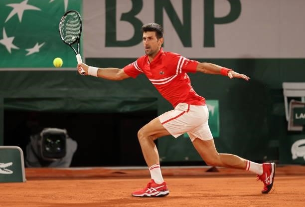 Novak Djokovic of Serbia hits a forehand during his Mens Singles Quarter-Final match against Matteo Berrettini of Italy during Day Eleven of the 2021...