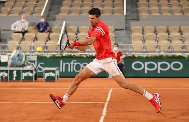Novak Djokovic of Serbia hits a backhand during his Mens Singles Quarter-Final match against Matteo Berrettini of Italy during Day Eleven of the 2021...