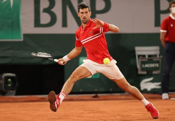 Novak Djokovic of Serbia hits a forehand during his Mens Singles Quarter-Final match against Matteo Berrettini of Italy during Day Eleven of the 2021...