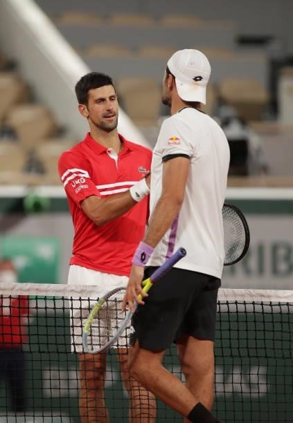 Novak Djokovic of Serbia interacts with Matteo Berrettini of Italy after victory in the Mens Singles Quarter-Final match during Day Eleven of the...