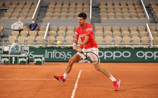 Novak Djokovic of Serbia hits a backhand during his Mens Singles Quarter-Final match against Matteo Berrettini of Italy during Day Eleven of the 2021...