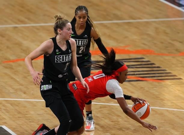 Odyssey Sims of the Atlanta Dream draws a foul as she battles for a rebound against Katie Lou Samuelson of the Seattle Storm in the first half at...