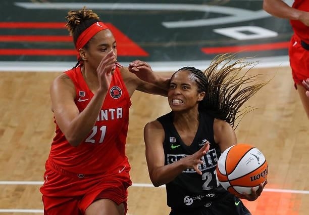 Jordin Canada of the Seattle Storm drives against Tianna Hawkins of the Atlanta Dream in the second half at Gateway Center Arena on June 09, 2021 in...
