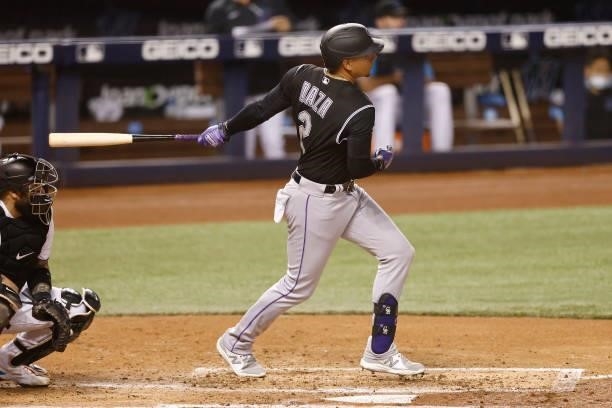 Yonathan Daza of the Colorado Rockies hits an RBI single during the third inning against the Miami Marlins at loanDepot park on June 09, 2021 in...