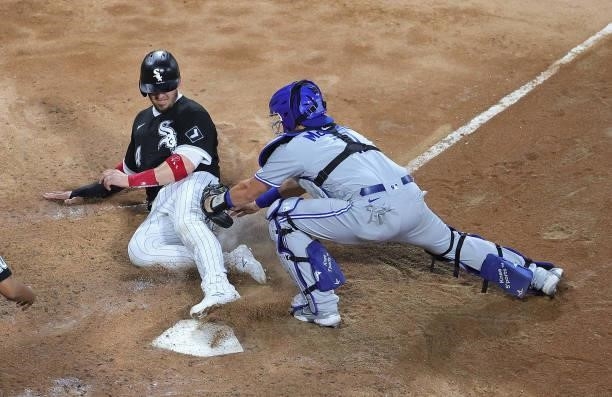 Yasmani Grandal of the Chicago White Sox is tagged out at the plate by Reese McGuire of the Toronto Blue Jays in the 4th inning at Guaranteed Rate...