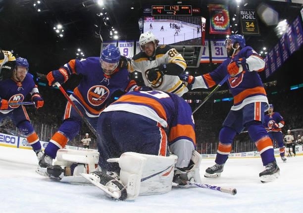 Semyon Varlamov of the New York Islanders covers the puck as David Pastrnak of the Boston Bruins looks for the rebound in Game Six of the Second...
