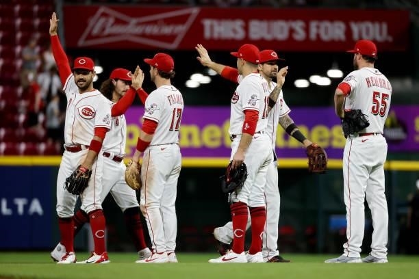 The Cincinnati Reds celebrate after beating the Milwaukee Brewers 7-3 at Great American Ball Park on June 09, 2021 in Cincinnati, Ohio.