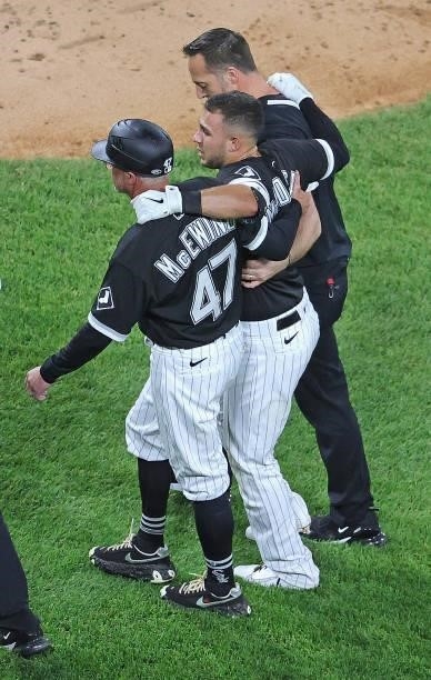 Nick Madrigal of the Chicago White Sox is helped off the field after suffering an injury in the 7th inning against the Toronto Blue Jays at...