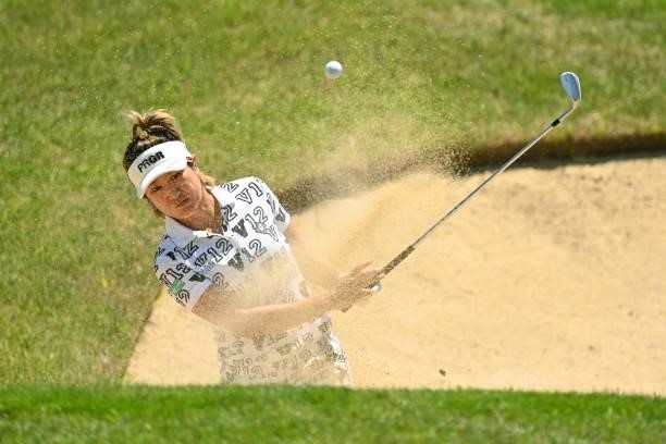 Asako Fujimoto of Japan hits out from a bunker on the 9th hole during the first round of the Ai Miyazato Suntory Ladies Open at Rokko Kokusai Golf...