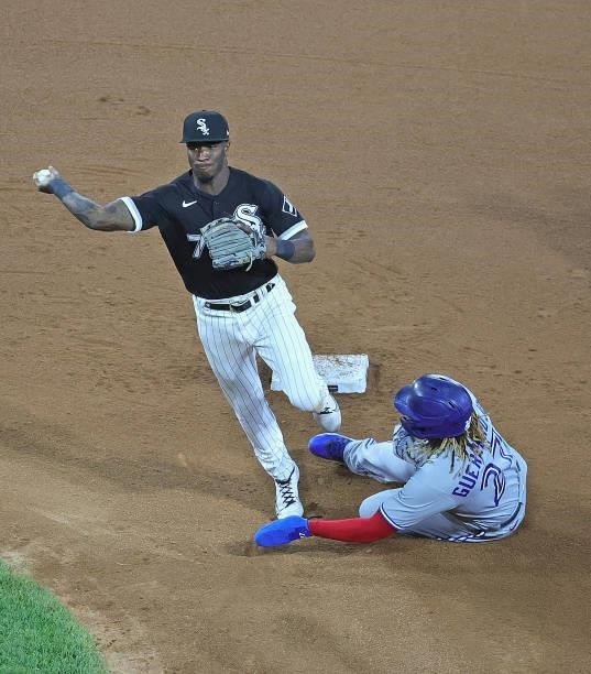 Tim Anderson of the Chicago White Sox attempts to turn a double play over Vladimir Guerrero Jr. #27 of the Toronto Blue Jays but is charged with a...