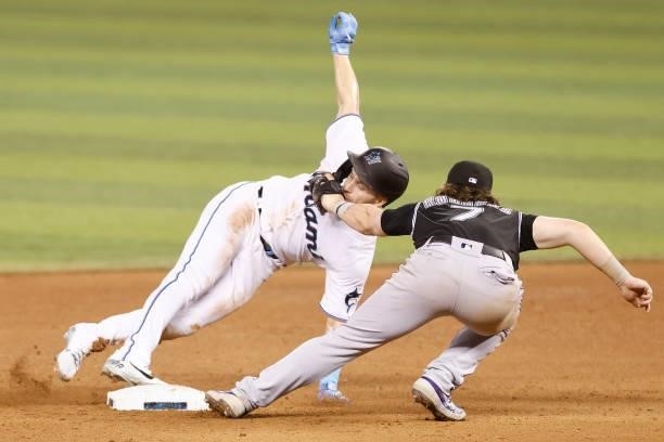Brendan Rodgers of the Colorado Rockies tags out Corey Dickerson of the Miami Marlins as he attempted to steal second base during the eighth inning...