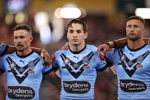 Damien Cook, Cameron Murray and Tariq Sims of the Blues prepare for the anthem during game one of the 2021 State of Origin series between the New...