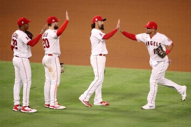 Raisel Iglesias, Jared Walsh, Anthony Rendon and Juan Lagares of the Los Angeles Angels celebrate their 6-1 win against the Kansas City Royals after...