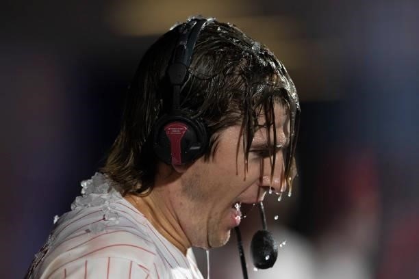 Luke Williams of the Philadelphia Phillies has ice water poured on him after hitting a walk-off two run home run in the bottom of the ninth inning...