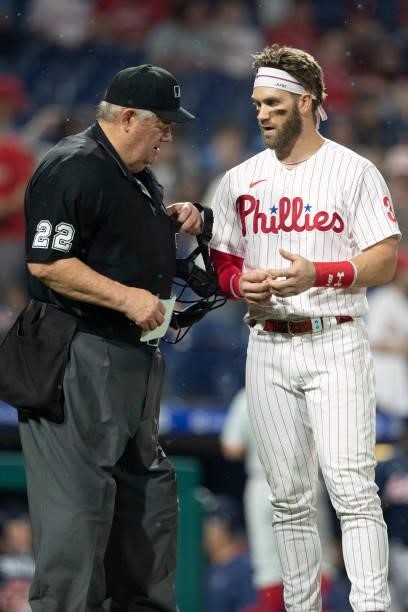 Umpire Joe West talks with Bryce Harper of the Philadelphia Phillies against the Atlanta Braves at Citizens Bank Park on June 9, 2021 in...