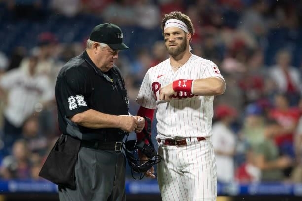 Umpire Joe West talks with Bryce Harper of the Philadelphia Phillies against the Atlanta Braves at Citizens Bank Park on June 9, 2021 in...