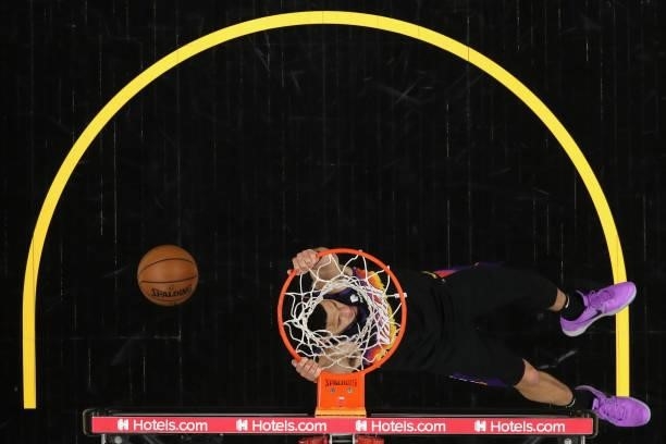Devin Booker of the Phoenix Suns slam dunks the ball against the Denver Nuggets during the first half in Game Two of the Western Conference...