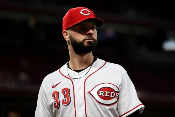 Jesse Winker of the Cincinnati Reds walks across the field in the sixth inning against the Milwaukee Brewers at Great American Ball Park on June 09,...